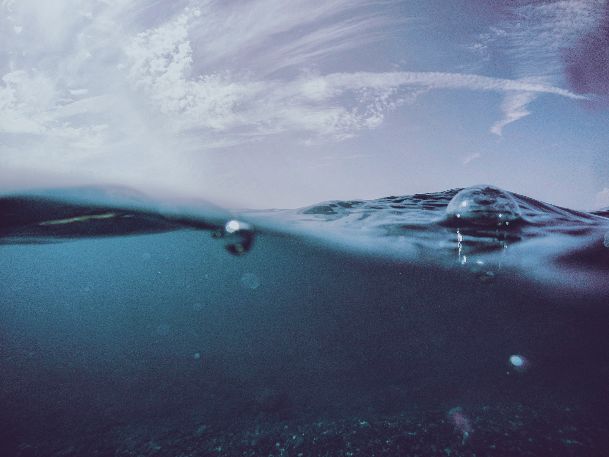 CLOSE-UP OF WATER SPLASHING AGAINST SEA